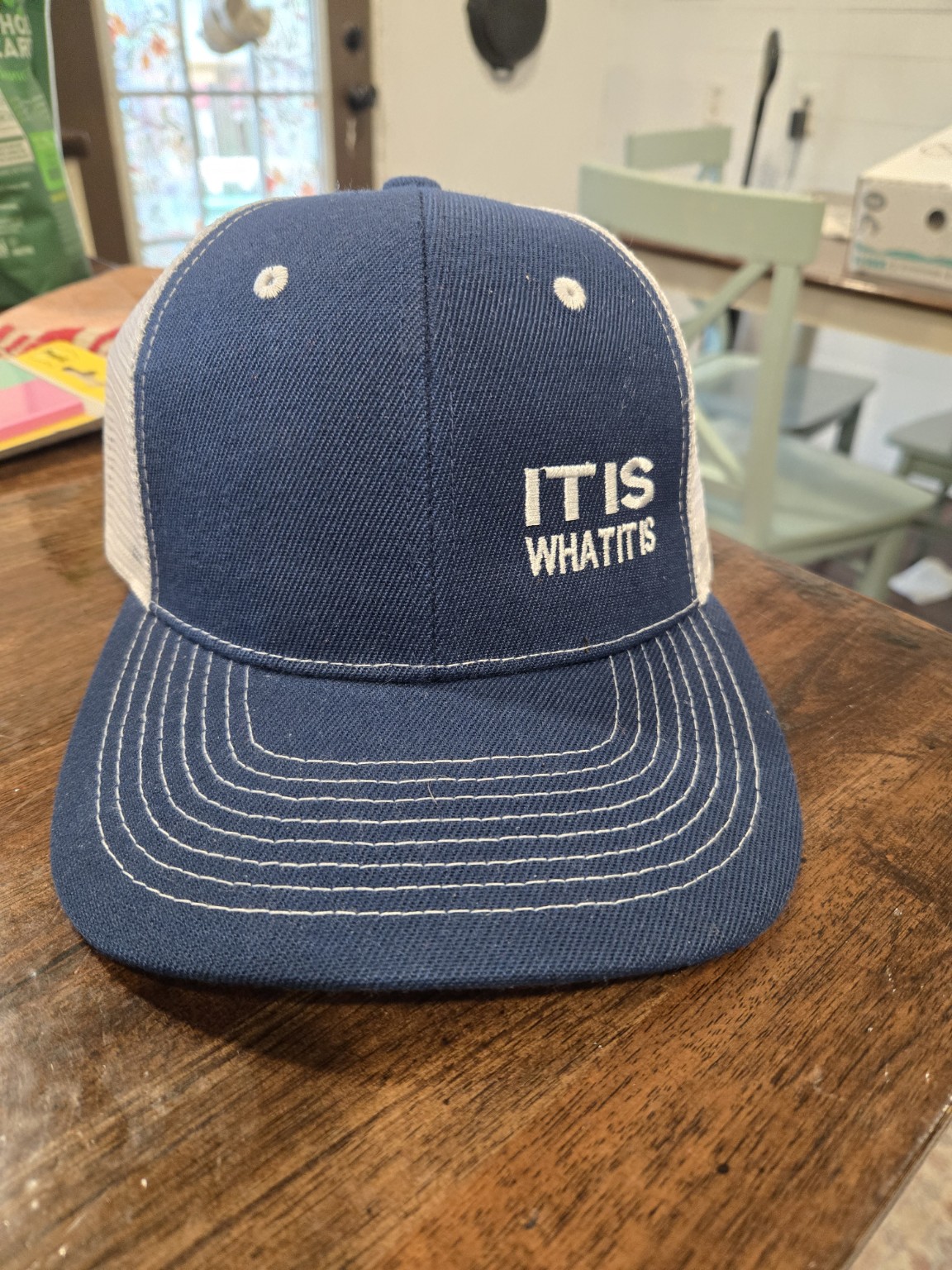 Casual saying embroidered on a gray trucker hat